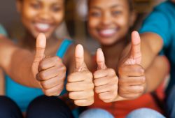 group of african friends thumbs up closeup